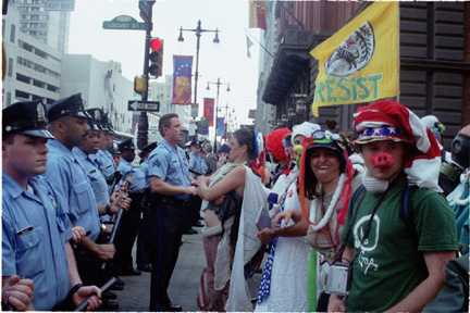 Clown protesters confront police